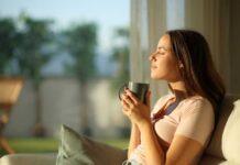 Woman enjoying a cup of coffee in a sunlit room