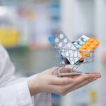 Beta Blocker Prescriptions: Millions Misled for Decades A doctor holding a miniature shopping cart filled with various medication packs