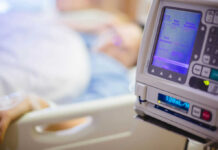 IV pump displaying medication flow rate in a hospital room