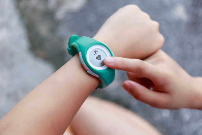 shutterstock_1789899068 Person using a fitness tracker on their wrist