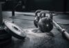 Kettlebells and weights on a gym floor with chalk dust