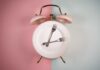 Foods That Spike Your Anxiety and Depression An alarm clock with a plate and two forks arranged in a creative design