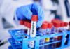Blood Test Twist Upends Depression Playbook A gloved hand holding a test tube labeled 'Legionella' among other samples