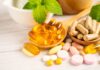 Best Foods and Supplements for your Gut Health Assorted vitamins and supplements arranged with mint leaves