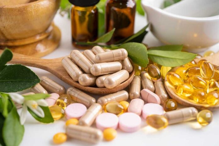 Alternative,Medicine,Herbal,Organic,Capsule,With,Vitamin,E,Omega,3 Various herbal supplements and vitamins arranged with leaves and a mortar