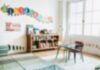 A bright and colorful children's room with a bookshelf and a play table