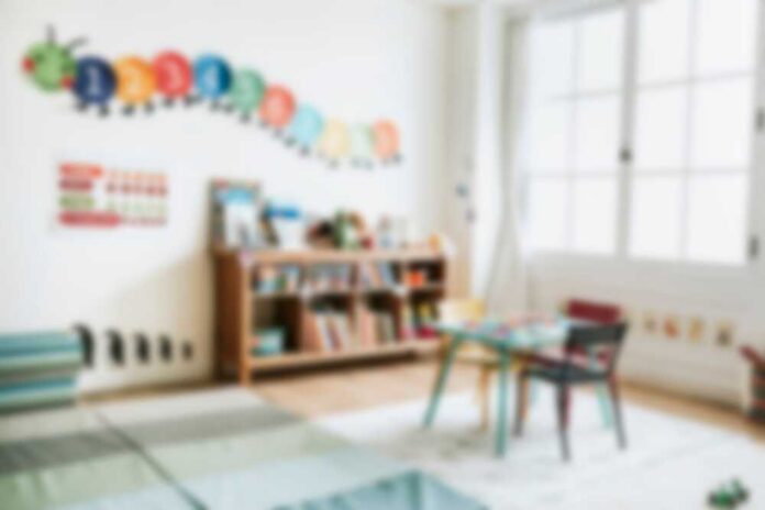 A bright and colorful children's room with a bookshelf and a play table