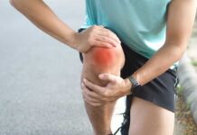 Stanford’s Bold Move Rewrites Arthritis Playbook Athlete holding their knee in pain while exercising outdoors