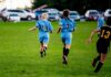 Could This Type Of Sport Be The Key To Better Sleep? Two girls running on a soccer field during a game