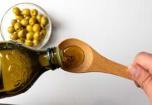 Diabetes Trigger Lurking In Everyday Diet Fat? Pouring olive oil from a bottle into a wooden spoon