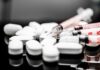 Depression Breakthrough: Hallucination-Free Brain Drugs White pills and syringes arranged on a reflective surface