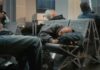 Passengers sleeping on airport benches with luggage nearby