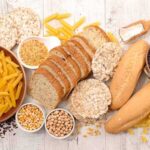 Gluten: A Benefit or Harm to the Body? Assorted grains and breads on a wooden table