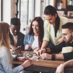 Group of friends playing a board game at a table