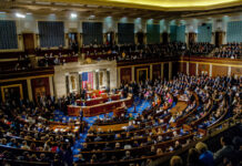 FDA Buried Vaccine Red Flags, Senators Charge A large gathering of officials in a congressional chamber during a legislative session