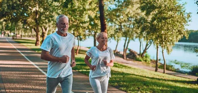 shutterstock_1191418468 Older couple jogging on a lakeside path
