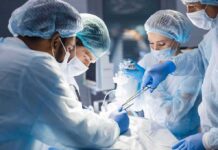 Glow-in-OR Drug Exposes Hidden Cancer Tumors surgeons performing an operation