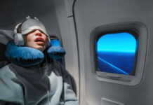 The CPAP Paradox — Fixed Apnea, Still Exhausted A passenger sleeping on an airplane with headphones and an eye mask