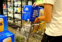 Processed Aisle: The Real Health Trap Shopper loading cases of beer into a grocery cart