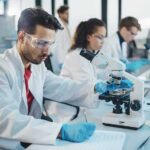 Heart-Safe Cancer Blocker Stuns Researchers Scientist using a microscope in a modern laboratory