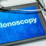 Why Early-Onset Cancer Is On the Rise Tablet displaying the word Colonoscopy with a stethoscope beside it
