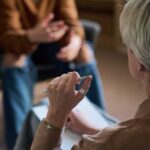 Suppressed Anger, Surprising Health Toll Two individuals engaged in a conversation during a counseling session