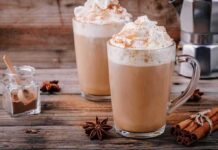 Midlife Caffeine, Big Late-Life Payoff Two latte mugs with whipped cream and cinnamon on a rustic table