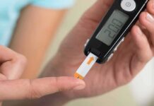 Late Night Habits Tied To DIABETES person using a blood glucose meter with a test strip
