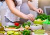 Hidden Plant Compounds Upend Cancer Risk Person preparing a fresh salad with green vegetables in a kitchen