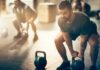 Man lifting a kettlebell in a gym