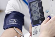 Person having blood pressure measured with digital monitor