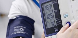 Person having blood pressure measured with digital monitor