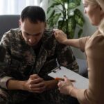 Soldier in camouflage receives support from a counselor
