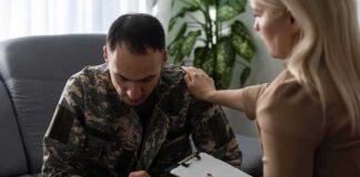 Soldier in camouflage receives support from a counselor
