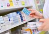 Menopause Rule Reversal Stuns Big Medicine pharmacist holding blister pack of blue capsules