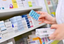 Menopause Rule Reversal Stuns Big Medicine pharmacist holding blister pack of blue capsules