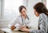 Doctor consulting a patient at a desk