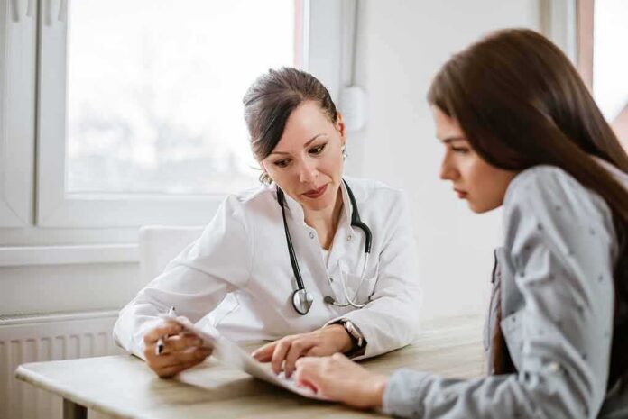 Doctor consulting a patient at a desk