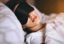 Hidden Hypertension Spikes While Patients Sleep Woman sleeping with a black eye mask in bed