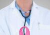 Doctor holding stethoscope with pink ribbon in front