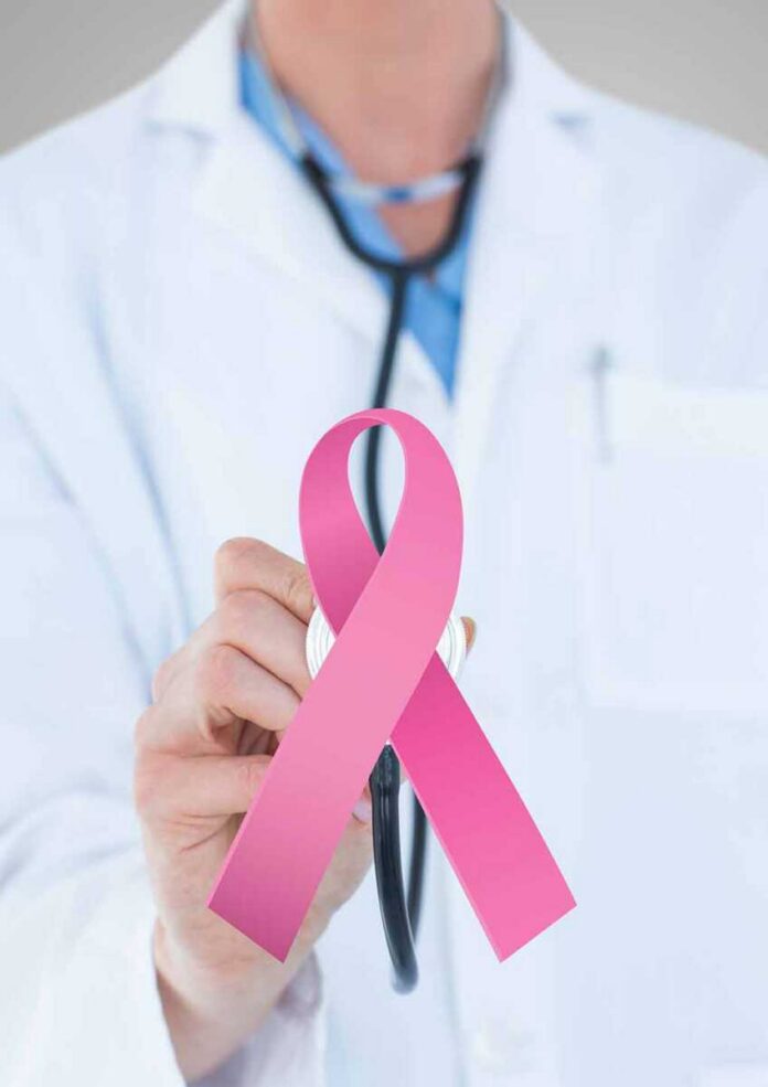 shutterstock_1087739549 Doctor holding stethoscope with pink ribbon in front
