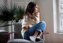 Doctors Missed This Anti-Loneliness Hack Woman sitting curled up on a chair looking out a window