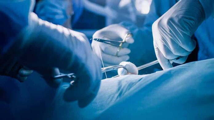 Surgeons' gloved hands performing an operation