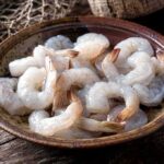 Raw shrimp in a rustic bowl