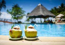 Kidney Nurse’s Coconut Water Warning Two coconut drinks with straws beside a swimming pool