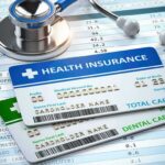 Health insurance cards on medical forms with stethoscope