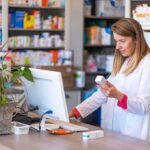 FDA Calls Out GLP-1 Microdose Hype Pharmacist checking medication box at computer counter