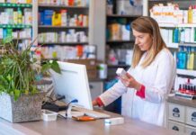 FDA Calls Out GLP-1 Microdose Hype Pharmacist checking medication box at computer counter