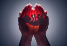 Hands cupping a glowing fetal silhouette