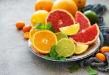 Assorted citrus slices on a plate with mint leaves